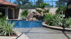 custom-gunite-lagoon-pool-beach-entry-tanning-ledge-laminar-jet-rico-rock-slide-waterfall-pebble-plaster-finish