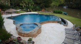 negative-edge-concrete-pool-ledger-stone-wall-raised-spa-diamond-brite-tahoe-blue-plaster