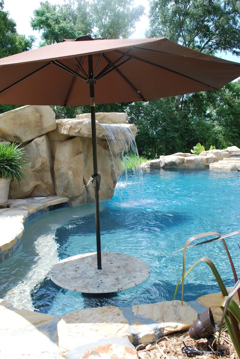 gunite pool with granite cocktail table rico rock waterfall pebble plaster umbrella holder
