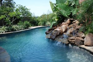 Natural shaped pool with flagstone coping and waterfall